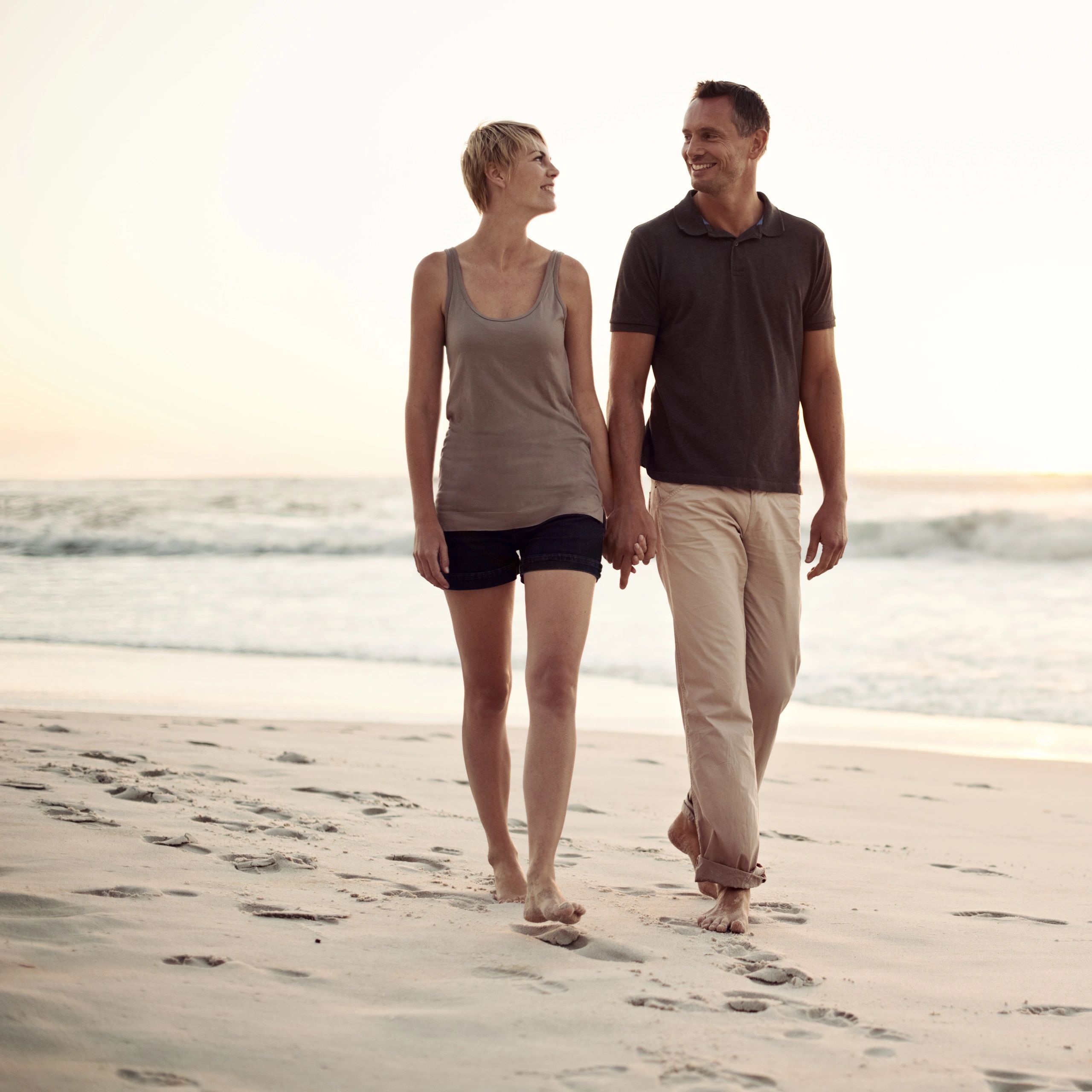 Couple walking along a tropical beach